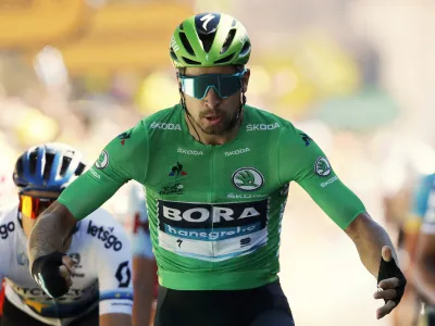 Slovakia's Peter Sagan wearing the best sprinter's green jersey celebrates as he crosses the finish line to win the fifth stage of the Tour de France cycling race over 175.5 kilometers (109 miles) with start in Saint-Die-Des-Vosges and finish in Colmar, Wednesday, July 10, 2019. (AP Photo/Christophe Ena)