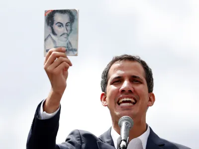 Juan Guaido, President of Venezuela's National Assembly, holds a copy of Venezuelan constitution during a rally against Venezuelan President Nicolas Maduro's government and to commemorate the 61st anniversary of the end of the dictatorship of Marcos Perez Jimenez in Caracas, Venezuela January 23, 2019. REUTERS/Carlos Garcia Rawlins