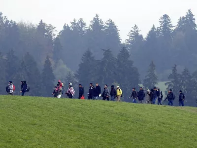 File photo of migrants crossing a field as they walk from the Austrian village of Kollerschlag towards the Austrian-German border in Wegscheid near Passau, Austria, October 20, 2015. In September, the leaders of Austria and Germany took one of the most pivotal decisions of Europe's refugee crisis, throwing open their borders to tens of thousands of migrants piling up in Hungary. Nearly half a year on, however, the display of unity over the Sept. 5-6 weekend is a distant memory. In a sign of how deep Europe's divisions over refugees have become, Berlin and Vienna snipe at each other almost daily. REUTERS/Michael Dalder/Files