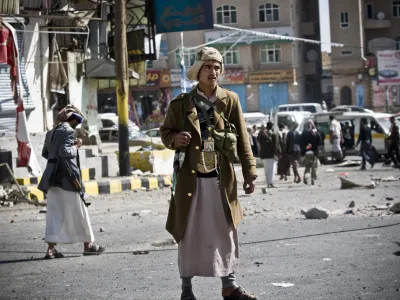 FILE - In this Tuesday, Jan. 20, 2015 file photo, Houthi Shiite Yemenis gather while guarding a street leading to the presidential palace in Sanaa, Yemen. The Shiite rebels, known as Houthis, captured the airport and city of Taiz -- a gateway to the south -- and have vowed to press on to Aden, the countrys economic hub, where President Abed Rabbo Mansour Hadi, a close U.S. ally, has taken refuge. (AP Photo/Hani Mohammed, File)