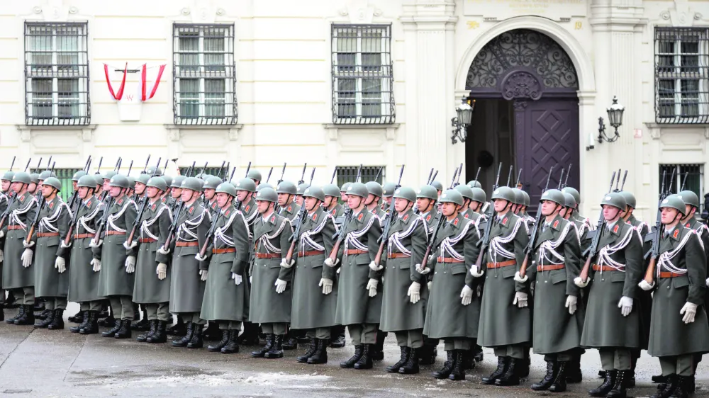 FILE - In this Jan. 15, 2013 file photo Austrian army soldiers stand in front of the chancellery in Vienna, Austria. Austrians eligible to vote are called to participate an army referendum, Sunday, Jan. 20, 2013. At issue in this neutral nation of just over 8 million people is whether to keep the present system that relies heavily on conscripts or to go with the European flow and create a professional army, as have 21 of the EU's 26 other members. The present model consists of about 35,000 troops, with about 14,000 professionals and the rest conscripts who serve for six months as well as a 30,000-strong part-time militia. (AP Photo/dapd, Hans Punz)