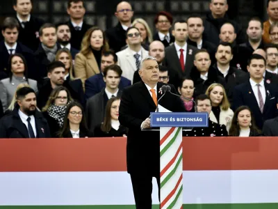Hungary's right-wing populist prime minister, Viktor Orban addresses thousands of supporters as they gather in Budapest, Hungary, Tuesday, March 15, 2022. The so-called "peace march" was a show of strength by Orban's supporters ahead of national elections scheduled for April 3, while a coalition of six opposition parties also held a rally in the capital. (AP Photo/Anna Szilagyi)