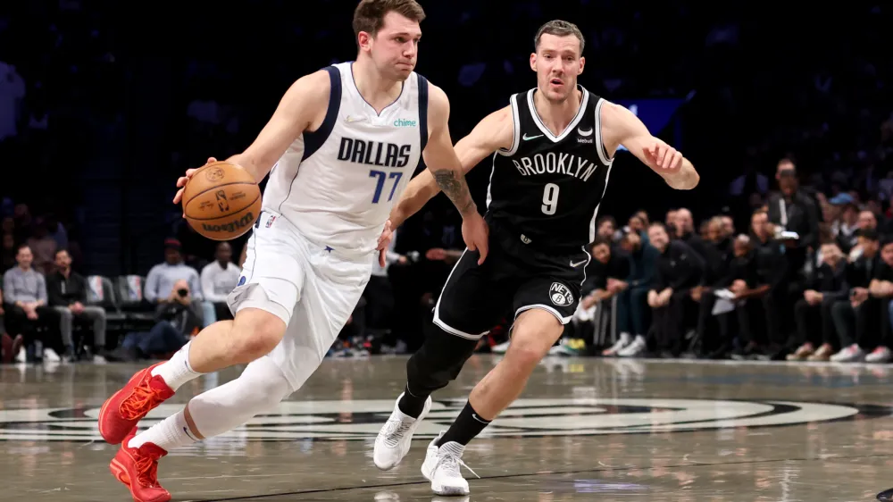 Mar 16, 2022; Brooklyn, New York, USA; Dallas Mavericks guard Luka Doncic (77) controls the ball against Brooklyn Nets guard Goran Dragic (9) during the first quarter at Barclays Center. Mandatory Credit: Brad Penner-USA TODAY Sports