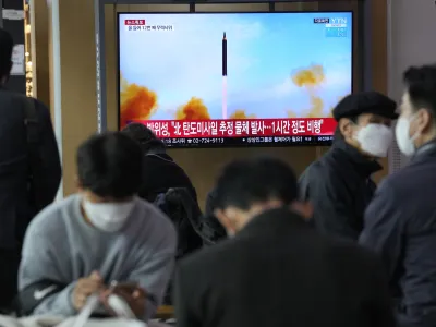 People watch a TV showing a file image of North Korea's missile launch during a news program at the Seoul Railway Station in Seoul, South Korea, Thursday, March 24, 2022. North Korea fired at least one suspected ballistic missile toward the sea Thursday, its neighbors' militaries said, apparently extending its barrage of weapons tests that may culminate with a flight of its biggest-yet intercontinental ballistic missile. (AP Photo/Ahn Young-joon)