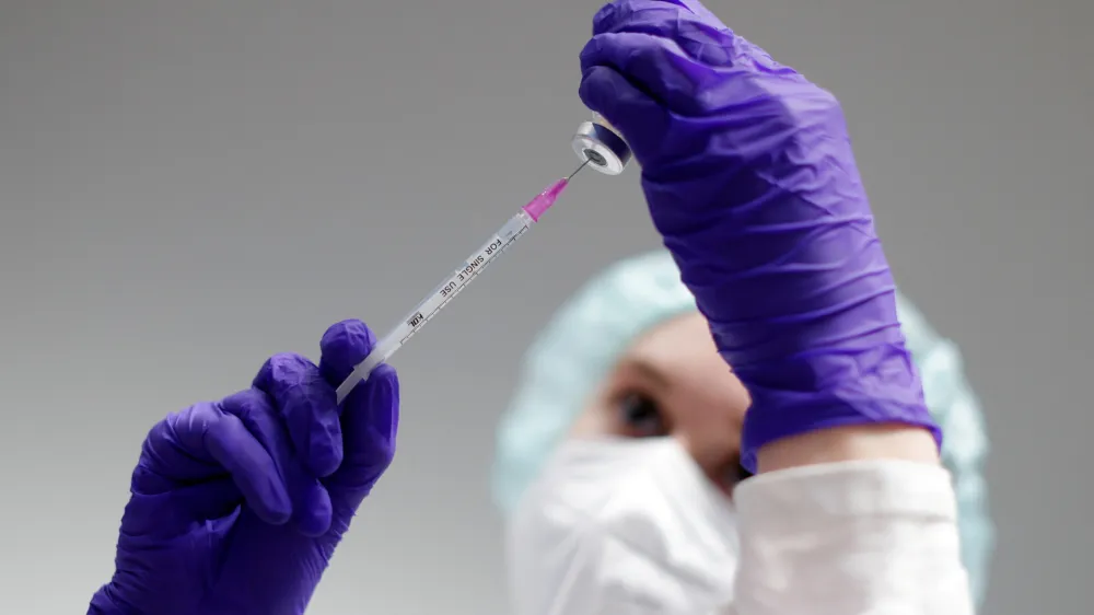 FILE PHOTO: A nurse prepares a shot of Pfizer-BioNTech coronavirus disease (COVID-19) vaccine at the vaccination centre in the Humboldt Forum in Berlin, Germany January 19, 2022. REUTERS/Michele Tantussi/File Photo