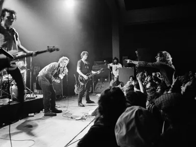 English punk rock group "Sex Pistols" get a form of audience participation on January 7, 1978 in Memphis, Tenn., during the second stop of their American tour. In left foreground is bass player Sid Vicious while group leader Johnny Rotten crouches in foreground. (AP Photo)