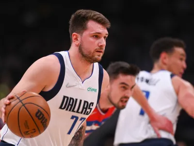 Apr 1, 2022; Washington, District of Columbia, USA;Dallas Mavericks guard Luka Doncic (77) dribble up court by Washington Wizards guard Tomas Satoransky (31) during the first half at Capital One Arena. Mandatory Credit: Tommy Gilligan-USA TODAY Sports