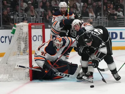Apr 7, 2022; Los Angeles, California, USA; Edmonton Oilers goaltender Mike Smith (41) and right wing Kailer Yamamoto (56) defend the goal against LA Kings center Phillip Danault (24) in the second period at Crypto.com Arena. Mandatory Credit: Kirby Lee-USA TODAY Sports