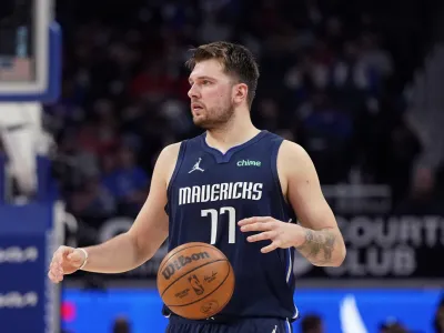 Dallas Mavericks guard Luka Doncic brings the ball up court during the second half of an NBA basketball game against the Detroit Pistons, Wednesday, April 6, 2022, in Detroit. (AP Photo/Carlos Osorio)