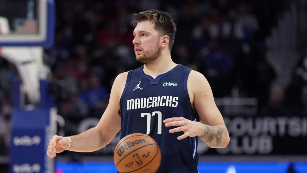 Dallas Mavericks guard Luka Doncic brings the ball up court during the second half of an NBA basketball game against the Detroit Pistons, Wednesday, April 6, 2022, in Detroit. (AP Photo/Carlos Osorio)