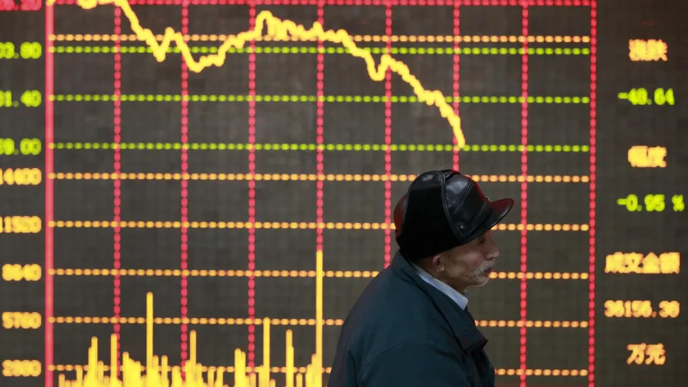 An investor stands in front of an electronic board showing stock information at a brokerage house in Huaibei, Anhui province January 11, 2013. China shares posted their worst daily loss in nearly four months on Friday, snapping a five-week winning streak after higher-than-expected December inflation crimped expectations for further monetary easing. REUTERS/Stringer (CHINA - Tags: BUSINESS TPX IMAGES OF THE DAY) CHINA OUT. NO COMMERCIAL OR EDITORIAL SALES IN CHINA