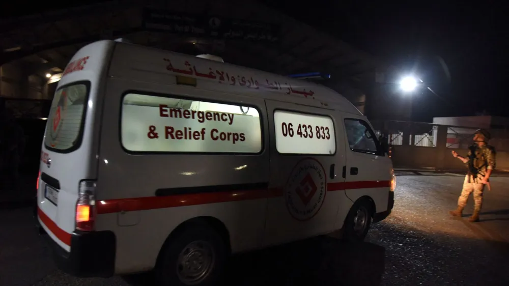 An ambulance drives at the entrance of the port of Tripoli, following the sinking of a boat off the coast of Lebanon's northern port city of Tripoli, in Tripoli, Lebanon April 23, 2022. Picture taken April 23, 2022. REUTERS/Omar Ibrahim