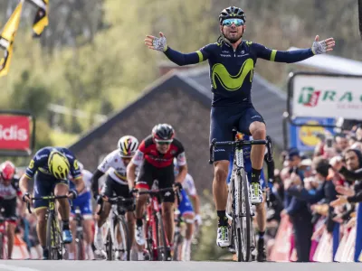 Spain's Alejandro Valverde of the Movistar team celebrates as he crosses the finish line to win the Walloon Arrow cycling race in Huy, Belgium on Wednesday April 19, 2017. Ireland's Daniel Martin of the Quick-Step finished second and Belgium's Dylan Teuns of the BMC Racing team finished third. (AP Photo/Geert Vanden Wijngaert)