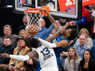 Apr 29, 2022; Minneapolis, Minnesota, USA; Minnesota Timberwolves forward Jaden McDaniels (3) dunks against the Memphis Grizzlies forward Jaren Jackson Jr. (13) in the fourth quarter during game six of the first round for the 2022 NBA playoffs at Target Center. Mandatory Credit: Brad Rempel-USA TODAY Sports