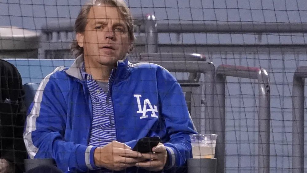 FILE - Los Angeles Dodgers co-owner Todd Boehly watches a baseball game against the Detroit Tigers Saturday, April 30, 2022, in Los Angeles. Chelsea is being sold to a consortium fronted by American sports investor Todd Boehly. It ends 19 years of ownership and lavish investment by Roman Abramovich until the Russian oligarch was sanctioned and forced to offload the Premier League club. The deal is worth 4.25 billion pounds ($5.24 billion). (AP Photo/Mark J. Terrill, File)