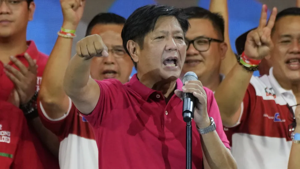 Presidential hopeful, former senator Ferdinand "Bongbong" Marcos Jr., the son of the late dictator, gestures as he greets the crowd during a campaign rally in Quezon City, Philippines on April 13, 2022. The winner of May 9, Monday's vote will inherit a sagging economy, poverty and deep divisions, as well as calls to prosecute outgoing leader Rodrigo Duterte for thousands of deaths as part of a crackdown on illegal drugs. (AP Photo/Aaron Favila)