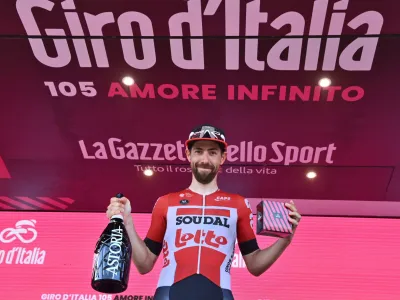 Belgium's Thomas De Gendt celebrates on the podium after winning the eighth stage of the Giro d'Italia cycling race, from Naples to Naples, Italy, Saturday, May 14, 2022. (Massimo Paolone/LaPresse via AP)
