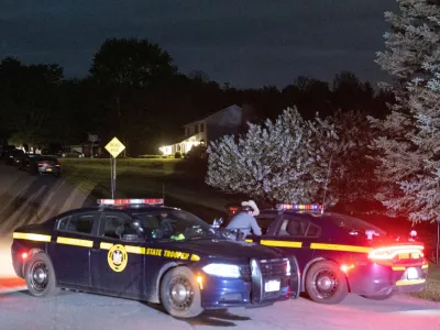 Law enforcement personnel are seen at the home of Buffalo supermarket shooting suspect Payton Gendron in Conklin, New York, U.S. May 14, 2022. REUTERS/Angus Mordant