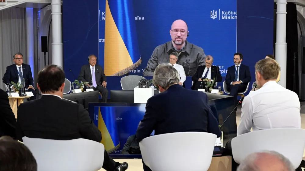 Ukrainian Prime Minister Denys Shmyhal is visible on a screen during the finance ministers and central bank chiefs meeting of the Group of 7 (G7) most industrialised nations in Koenigswinter, near Bonn, Germany May 19, 2022.   Federico Gambarini/Pool via REUTERS