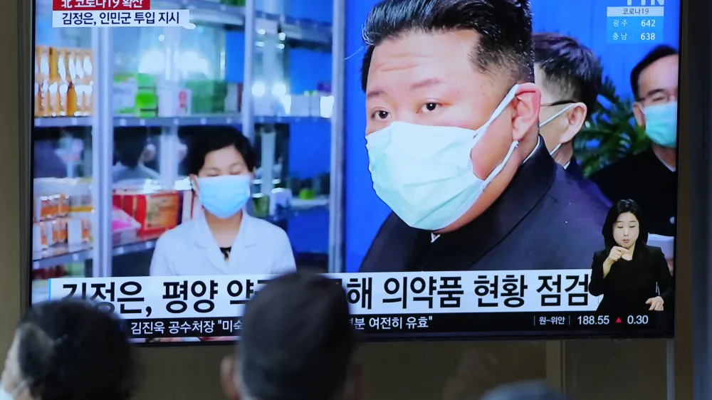 FILE - People watch a TV screen showing a news program reporting with an image of North Korean leader Kim Jong Un, at a train station in Seoul, South Korea on May 16, 2022. North Korea said Friday, May 20, that nearly 10% of its 26 million people have fallen ill and 65 people have died amid its first COVID-19 outbreak, as outside experts question the validity of its reported fatalities and worry about a possible humanitarian crisis. (AP Photo/Lee Jin-man, File)