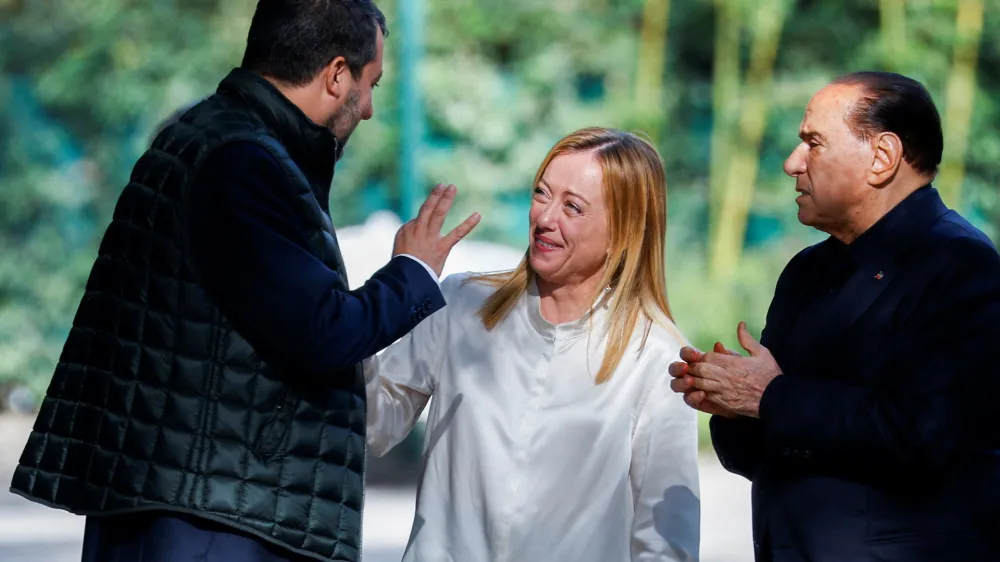FILE PHOTO: Former Italian Prime Minister and leader of the Forza Italia party Silvio Berlusconi looks on as League leader Matteo Salvini speaks to Brothers of Italy leader Giorgia Meloni at the end of their meeting in Rome, Italy, October 20, 2021. REUTERS/Guglielmo Mangiapane/File Photo