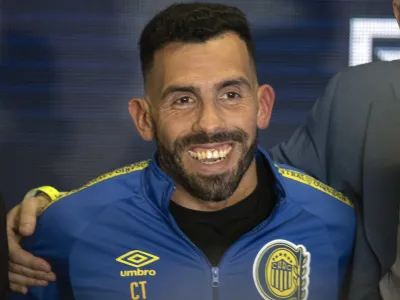 Former Boca Juniors star Carlos Tevez smiles wearing the team&acute;s jersey during his presentation as the new coach for Rosario Central, in Rosario, Argentina, Tuesday, June 21, 2022. (AP Photo/Franco Trovato)