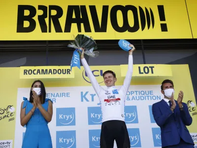 Cycling - Tour de France - Stage 20 - Lacapelle-Marival to Rocamadour - France - July 23, 2022 UAE Team Emirates' Tadej Pogacar celebrates on the podium wearing the white jersey after stage 20 REUTERS/Gonzalo Fuentes
