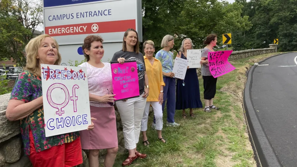 Residents from various communities in mostly rural northeastern Connecticut stage a protest outside Day Kimball Hospital, Monday, July 18, 2022 in Putnam, Conn. The protesters are concerned with Day Kimball Healthcare's plans to affiliate with Covenant Healthcare, a Catholic health system that abides by directives set by the U.S. Conference of Catholic Bishops. (AP Photo/Susan Haigh)