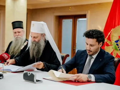Montenegro's Prime Minister Dritan Abazovic and the Serbian Orthodox Church Patriarch Porfirije?meet to sign a contract regulating their ties, in Podgorica, Montenegro August 3, 2022. Government of Montenegro/Handout via REUTERS ATTENTION EDITORS - THIS PICTURE WAS PROVIDED BY A THIRD PARTY. NO RESALES. NO ARCHIVES.
