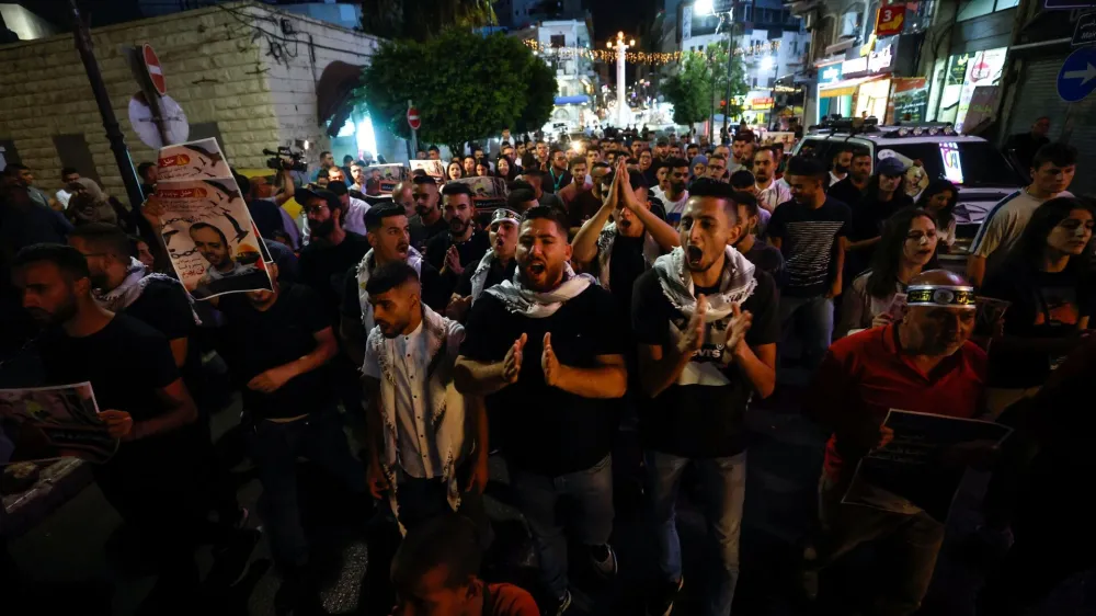 Palestinians attend a protest against Israeli strikes in Gaza, in Ramallah, in the Israeli-occupied West Bank August 5, 2022. REUTERS/Mohamad Torokman