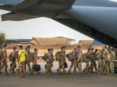 FILE - French Barkhane force soldiers who wrapped up a four-month tour of duty in the Sahel leave their base on a US Air Force C130 transport plane in Gao, Mali, June 9, 2021. French President Emmanuel Macron announced at a press conference Thursday Feb. 17, 2022 that he is withdrawing French troops from Mali. France intends to maintain its military operations to fight Islamic extremism in other countries in Africa's broader Sahel region. (AP Photo/Jerome Delay, File)