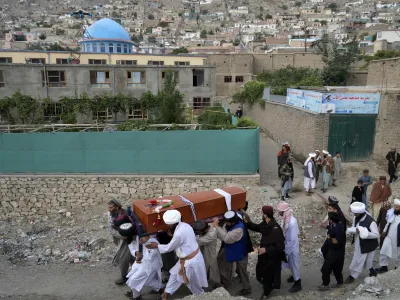 Mourners carry the body of a victim of a mosque bombing in Kabul, Afghanistan, Thursday, Aug. 18. 2022. A bombing at a mosque in Kabul during evening prayers on Wednesday killed at least 10 people, including a prominent cleric, and wounded over two dozen, an eyewitness and police said. (AP Photo/Ebrahim Noroozi)