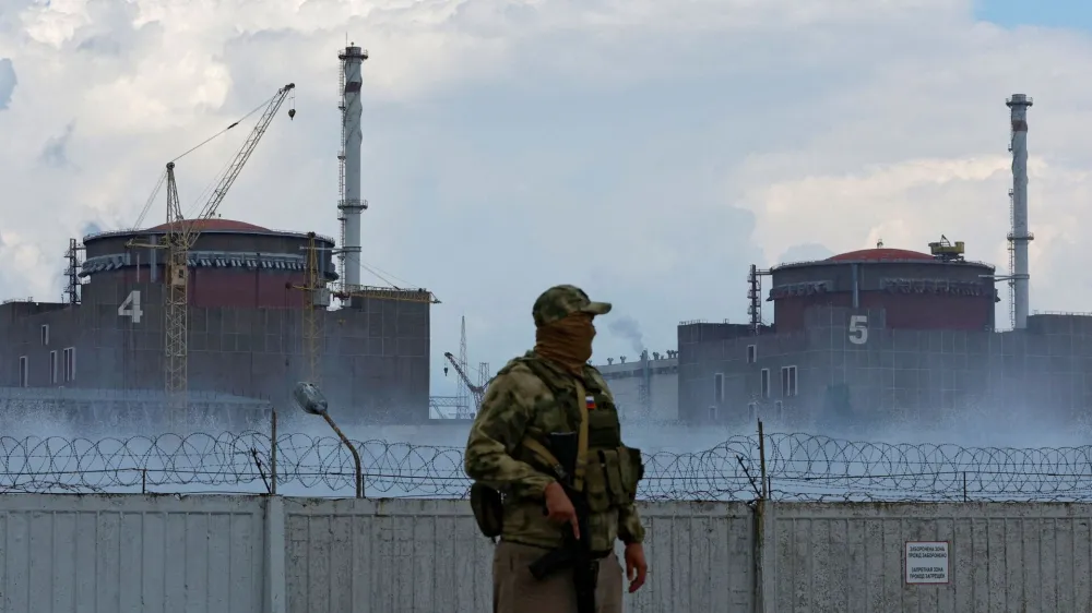 FILE PHOTO: A serviceman with a Russian flag on his uniform stands guard near the Zaporizhzhia Nuclear Power Plant in the course of Ukraine-Russia conflict outside the Russian-controlled city of Enerhodar in the Zaporizhzhia region, Ukraine August 4, 2022. REUTERS/Alexander Ermochenko/File Photo