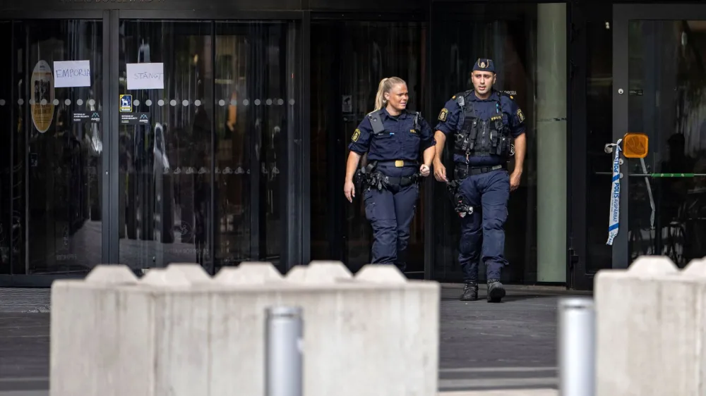 Police officers walk out of the Emporia Shopping Center, following a shooting, in Malmo, Sweeden August 20, 2022. TT News Agency/Johan Nilsson via REUTERS ATTENTION EDITORS - THIS IMAGE WAS PROVIDED BY A THIRD PARTY. SWEDEN OUT. NO COMMERCIAL OR EDITORIAL SALES IN SWEDEN.