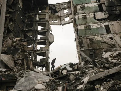 FILE - A resident looks for belongings in the ruins of an apartment building destroyed during fighting between Ukrainian and Russian forces in Borodyanka, Ukraine, Tuesday, April 5, 2022. (AP Photo/Vadim Ghirda, File)