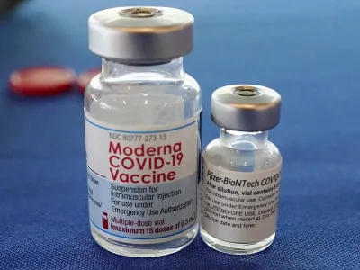 FILE - This Sept. 21, 2021 file photo shows vials of the Pfizer and Moderna COVID-19 vaccines in Jackson, Miss. Moderna is suing its main competitors Pfizer and the German drugmaker BioNTech, accusing the rivals of copying Moderna's technology in order to make their own vaccine. Moderna said Friday, Aug. 26, 2022, that Pfizer and BioNTech's vaccine Comirnaty infringes on patents Moderna filed several years ago protecting the technology behind its preventive shot, Spikevax. (AP Photo/Rogelio V. Solis, File)