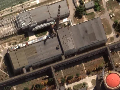 This satellite image provided by Maxar Technologies shows recent damage to the roof of a building adjacent to several of the nuclear reactors at the Zaporizhzhia nuclear plant in Russian occupied Ukraine, Monday Aug. 29, 2022. A team from the U.N. nuclear watchdog on Monday started its journey to the Zaporizhzhia atomic power plant at the heart of fighting in Ukraine, a long-awaited mission to inspect crucial safety systems that the world hopes will help avoid a catastrophe. (Satellite image &copy;2022 Maxar Technologies via AP)