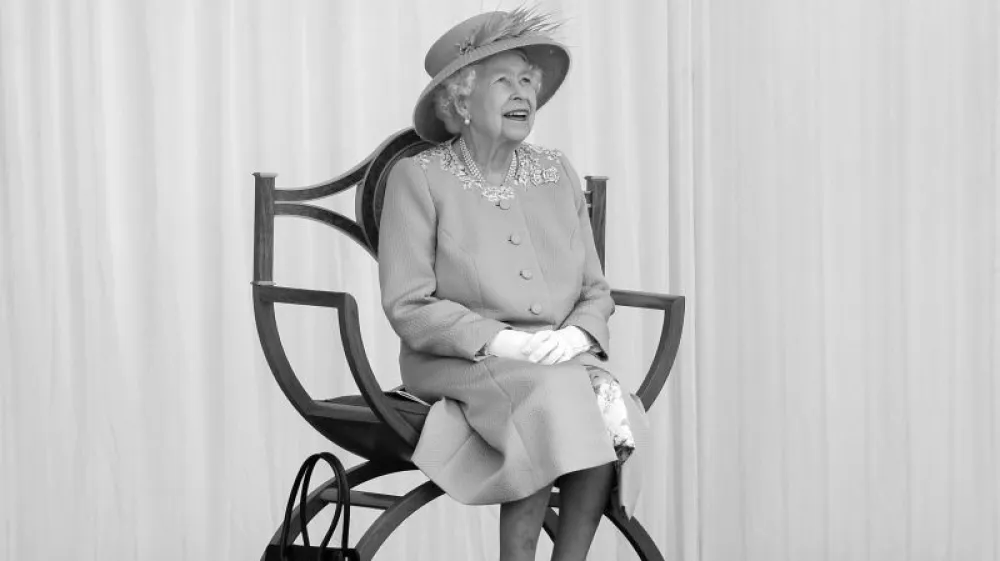 FILE - Britain's Queen Elizabeth II watches the red arrows fly over to mark her official birthday at Windsor Castle, Windsor, England, Saturday June 12, 2021. Elizabeth was born on April 21, 1926, but it was sometimes confusing for the public to know when to celebrate. There was no universally fixed day for her "official birthday": It's either the first, second or third Saturday in June, and was decided by the government. (Chris Jackson/Pool via AP, File)