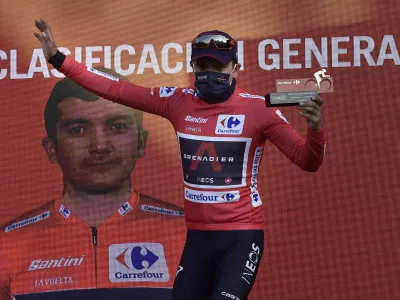Ineos's Richard Carapaz, red shirt leader of La Vuelta, on the podium after crossing the finish line on second position behind Jumbo's Primoz Roglic at the end of the eighth stage of La Vuelta between Logrono and Alto de Moncalvillo, in Logrono, northern Spain, Wednesday, Oct. 28, 2020. (AP Photo/Alvaro Barrientos)