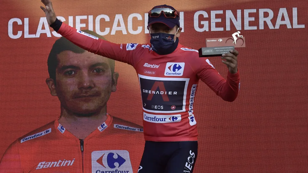 Ineos's Richard Carapaz, red shirt leader of La Vuelta, on the podium after crossing the finish line on second position behind Jumbo's Primoz Roglic at the end of the eighth stage of La Vuelta between Logrono and Alto de Moncalvillo, in Logrono, northern Spain, Wednesday, Oct. 28, 2020. (AP Photo/Alvaro Barrientos)