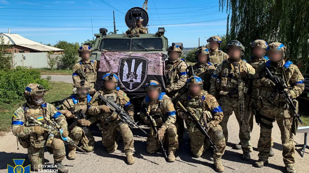 Service members of the State Security Service of Ukraine pose for a picture in the recently liberated town of Kupiansk, amid Russia's attack on Ukraine, in Kharkiv region, Ukraine in this handout picture released September 10, 2022. Press Service of the State Security Service of Ukraine/Handout via REUTERS ATTENTION EDITORS - THIS IMAGE HAS BEEN SUPPLIED BY A THIRD PARTY. DO NOT OBSCURE LOGO. THE IMAGE HAS BEEN BLURRED AT SOURCE.