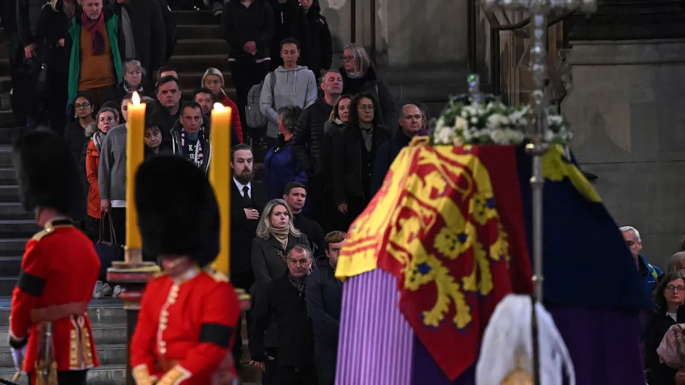 Members of the public pay their respects as they pass the coffin of Queen Elizabeth II, Lying in State inside Westminster Hall, at the Palace of Westminster in London, Sunday, Sept. 18, 2022. (Paul Ellis/Pool Photo via AP)