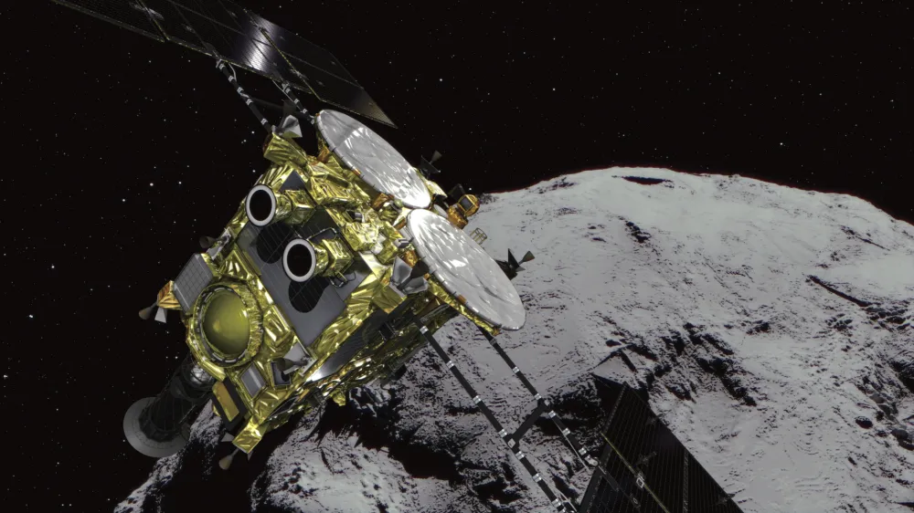 This computer graphics image provided by the Japan Aerospace Exploration Agency (JAXA) shows an asteroid and asteroid explorer Hayabusa2. The Japanese space explorer that will try to blow a crater in an asteroid and bring back samples from inside is nearing its destination after a 3 1/2 -year journey. The unmanned Hayabusa2 has arrived at the asteroid Wednesday, June 27, 2018, about 280 million kilometers (170 million miles) from Earth.(JAXA via AP)