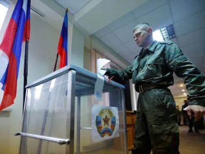 A service member of the self-proclaimed Luhansk People's Republic (LPR) votes during a referendum on joining LPR to Russia, at a military unit in Luhansk, Ukraine September 23, 2022. REUTERS/Alexander Ermochenko