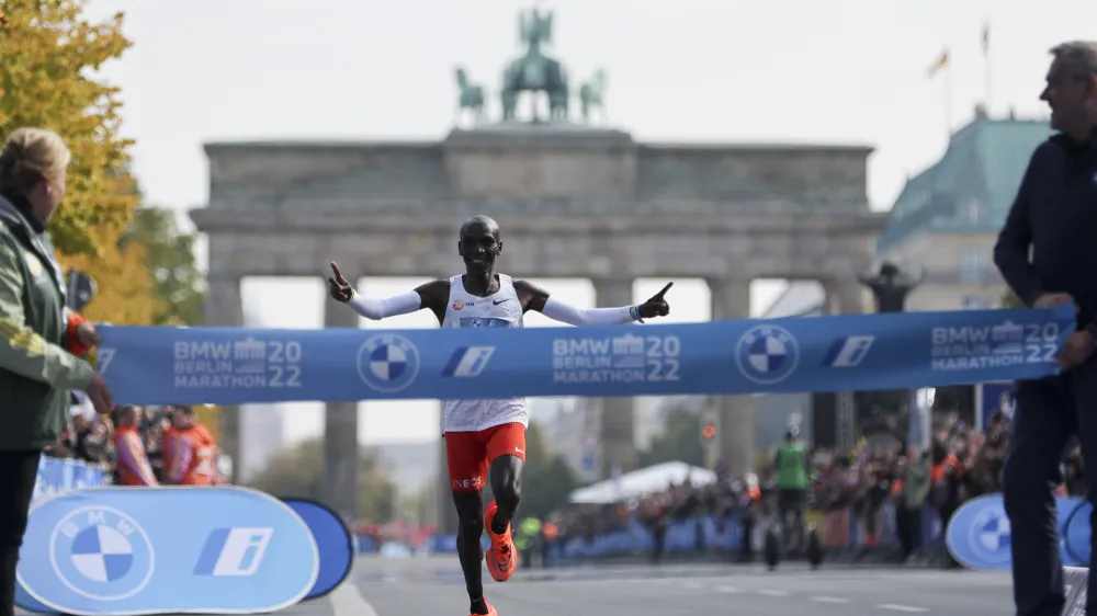 Kenya's Eliud Kipchoge crosses the line to win the Berlin Marathon in Berlin, Germany, Sunday, Sept. 25, 2022. Olympic champion Eliud Kipchoge has bettered his own world record in the Berlin Marathon. Kipchoge clocked 2:01:09 on Sunday to shave 30 seconds off his previous best-mark of 2:01:39 from the same course in 2018. (AP Photo/Christoph Soeder)