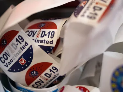 FILE PHOTO: Patients receive stickers after receiving the coronavirus disease (COVID-19) booster vaccine targeting BA.4 and BA.5 Omicron sub variants at Skippack Pharmacy in Schwenksville, Pennsylvania, U.S., September 8, 2022. REUTERS/Hannah Beier/File Photo