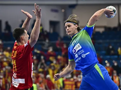 Handball - EHF 2022 Men's European Handball Championship - Group A - Slovenia v North Macedonia - Fonix Arena, Debrecen, Hungary - January 13, 2022 Slovenia's Jure Dolenec in action with North Macedonia's Filip Taleski REUTERS/Marton Monus