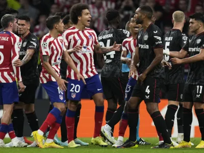 Teams' players argue during the group B Champions League soccer match between Atletico Madrid and Bayer 04 Leverkusen at the Civitas Metropolitano stadium in Madrid, Spain, Wednesday, Oct. 26, 2022. (AP Photo/Manu Fernaandez)