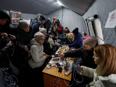 Local residents charge their devices, use internet connection and warm up inside an invincibility centre after critical civil infrastructure was hit by Russian missile attacks in Kyiv, Ukraine November 24, 2022. REUTERS/Valentyn Ogirenko   TPX IMAGES OF THE DAY