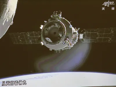 In this image made off the screen at the Beijing Aerospace Control Center in Beijing and released by China's Xinhua News Agency, Shenzhou-9 manned spacecraft parts from the orbiting Tiangong-1 space lab, partly seen on left, to prepare for the country's first manual space docking Sunday, June 24, 2012. The Chinese spacecraft and the space lab were joined together by an automated docking on June 18. (AP Photo/Beijing Aerospace Control Center via Xinhua) NO SALES